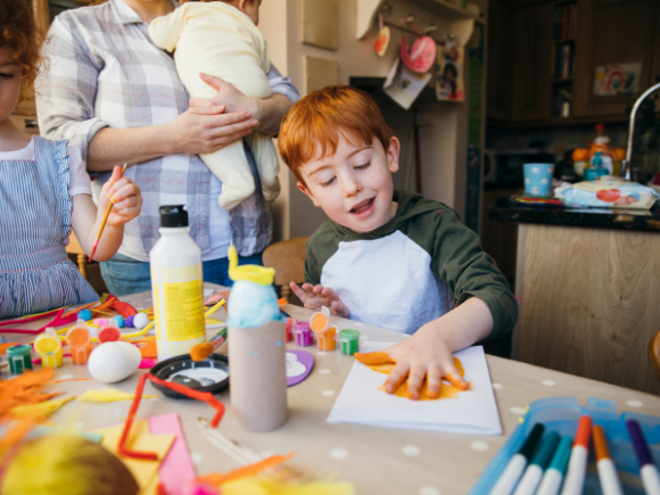Toddler boy painting with his hands Toddler boy painting with his hands