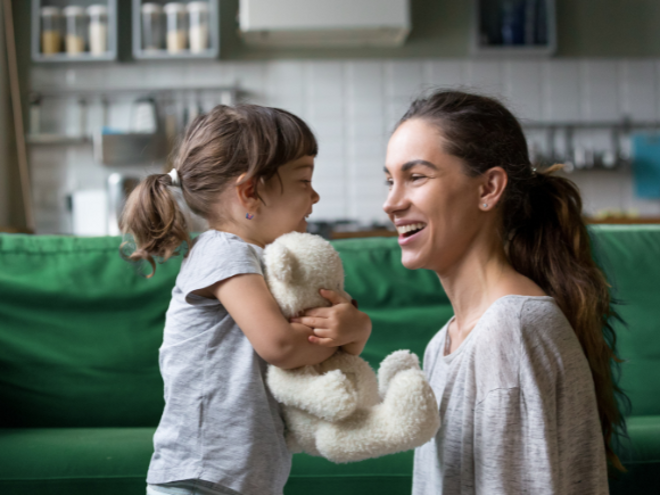 Mother smiling while talking to toddler girl Mother smiling while talking to toddler girl