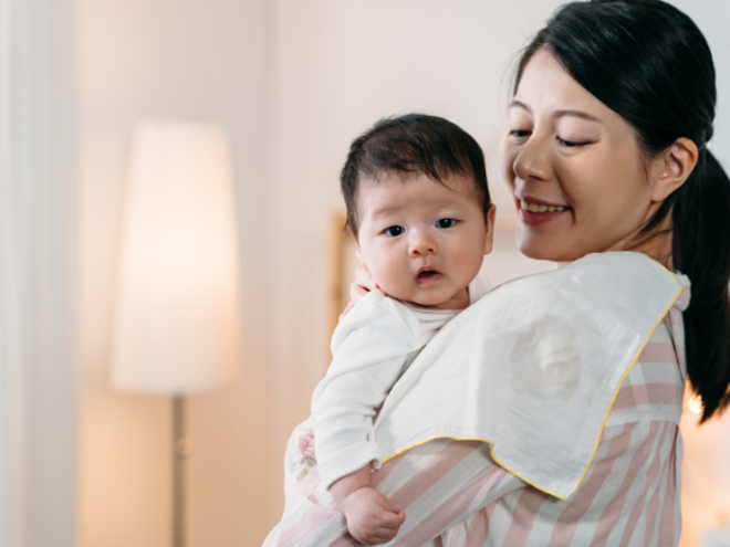 mother holding her baby with towel on her shoulder mother holding her baby with towel on her shoulder