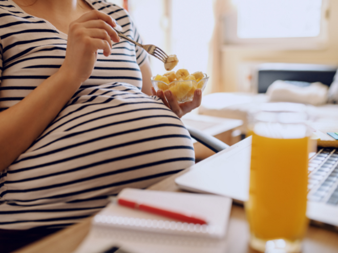 Pregnant woman eating banana Pregnant woman eating banana
