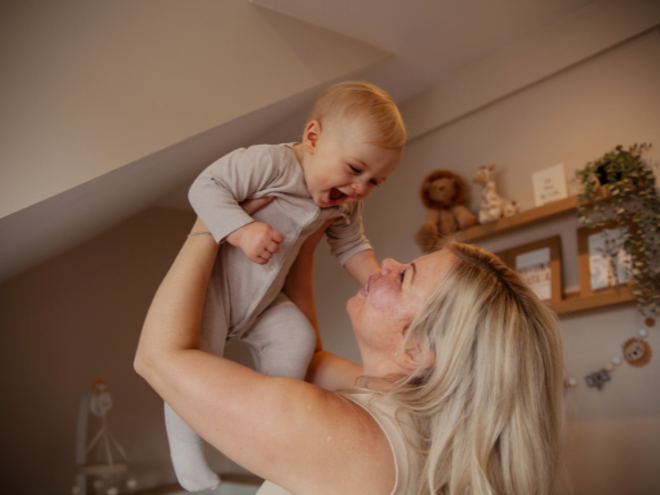 Mother holding baby in the air Mother holding baby in the air