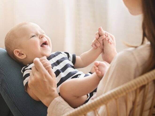 Baby on mothers lap holding mothers hand Baby on mothers lap holding mothers hand