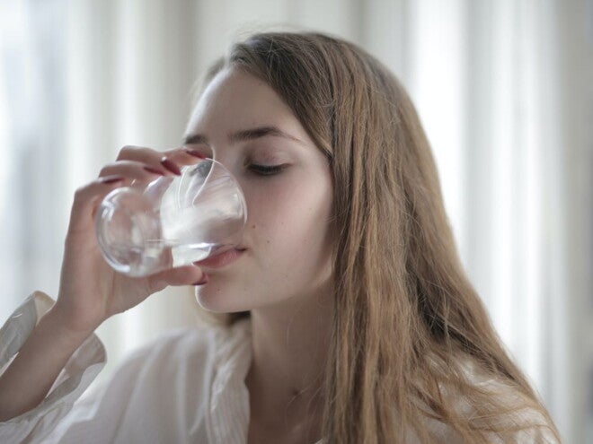 Woman drinking water from a glass Woman drinking water from a glass