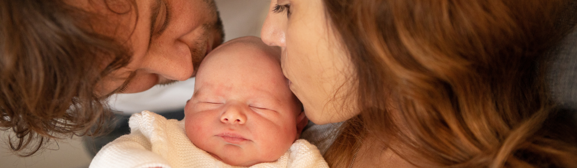 mother and father kissing their newborn baby mother and father kissing their newborn baby