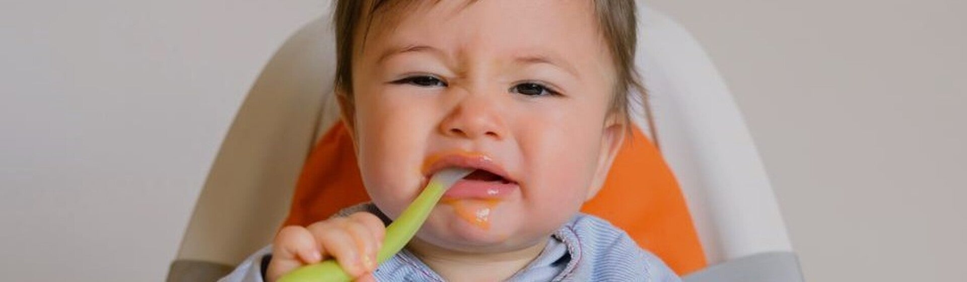 Baby with spoon in mouth looking unimpressed Baby with spoon in mouth looking unimpressed