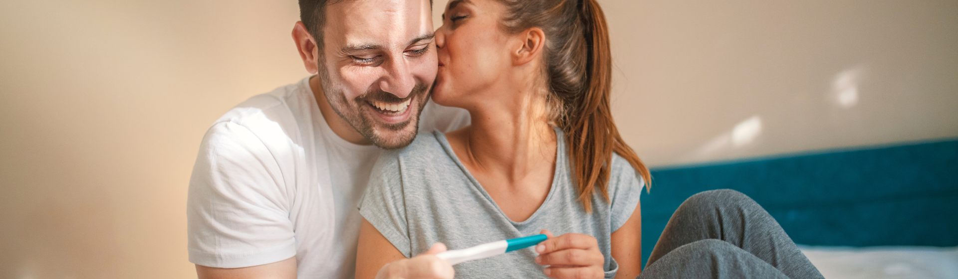 couple holding a pregnancy test couple holding a pregnancy test