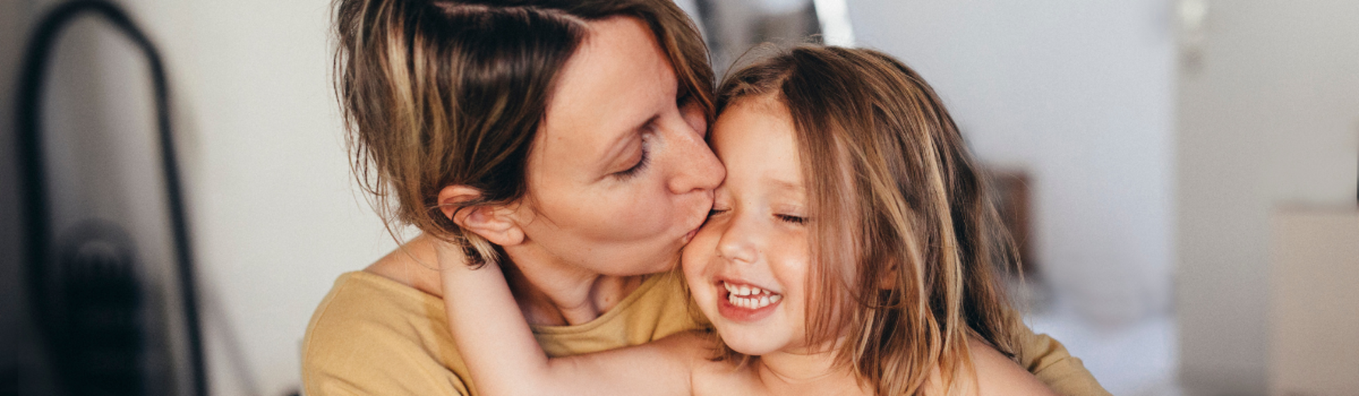 Mother kissing her daughter Mother kissing her daughter
