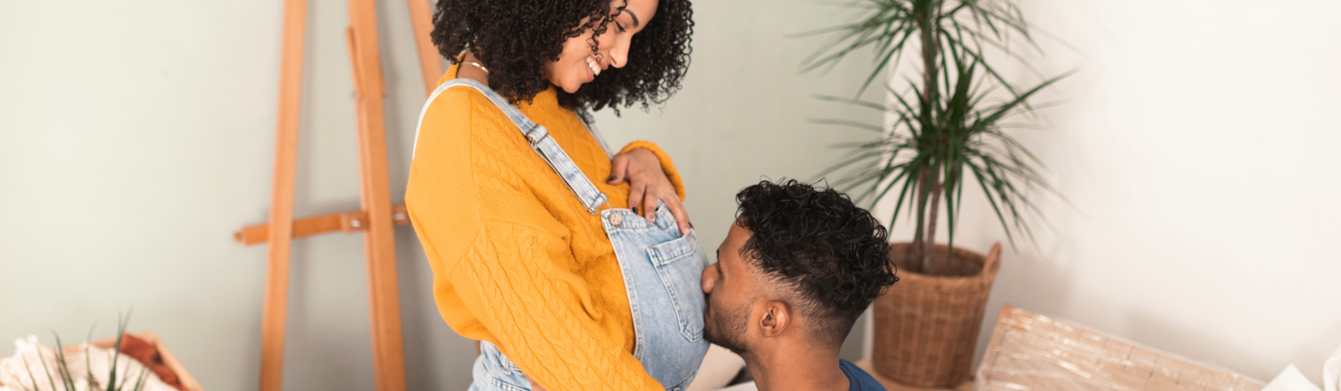 Man kissing pregnant womans stomach Man kissing pregnant womans stomach