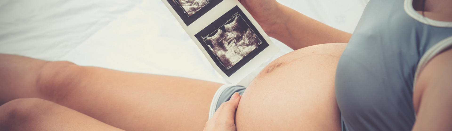 Pregnant woman holding a baby scan image Pregnant woman holding a baby scan image