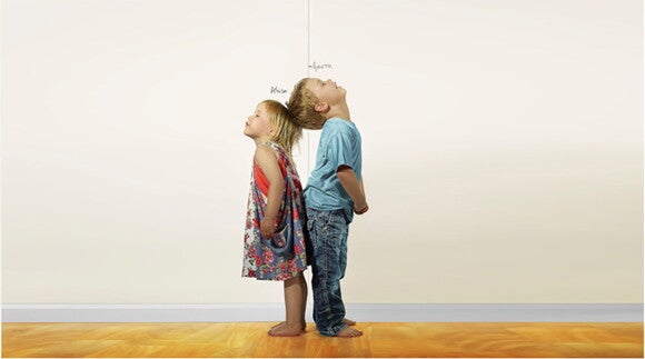 children standing back to back comparing height children standing back to back comparing height
