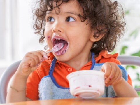 toddler eating yoghurt toddler eating yoghurt