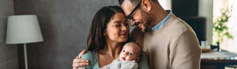 mother and father holding their baby mother and father holding their baby